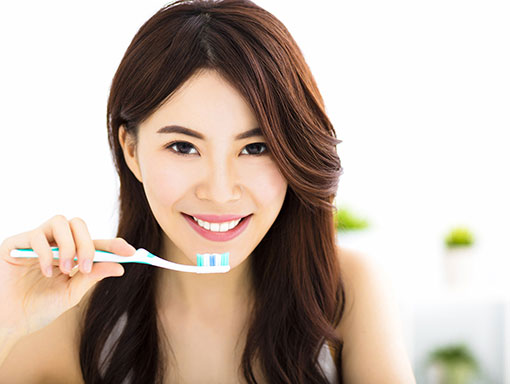 girl smiling with toothbrush