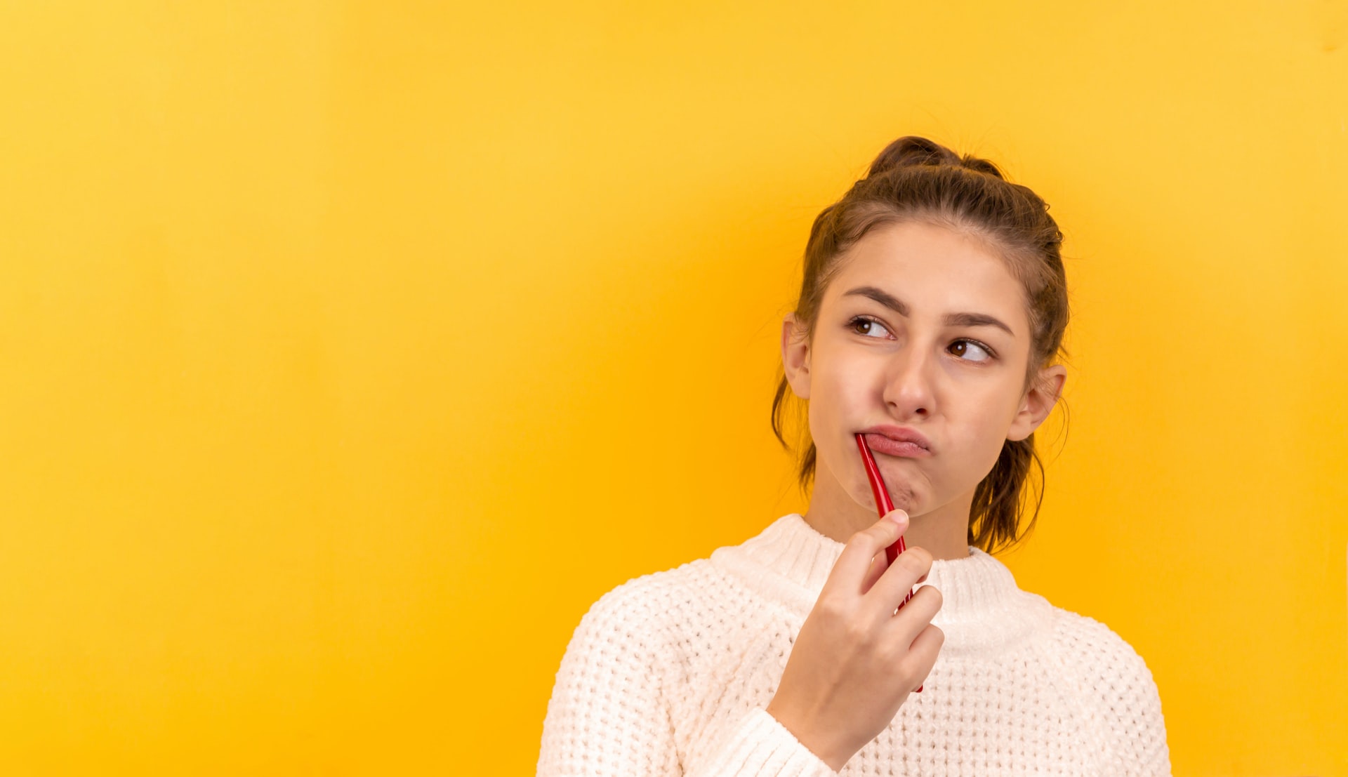 Girl with a toothbrush in her mouth considers oral care tips from Las Vegas dentists