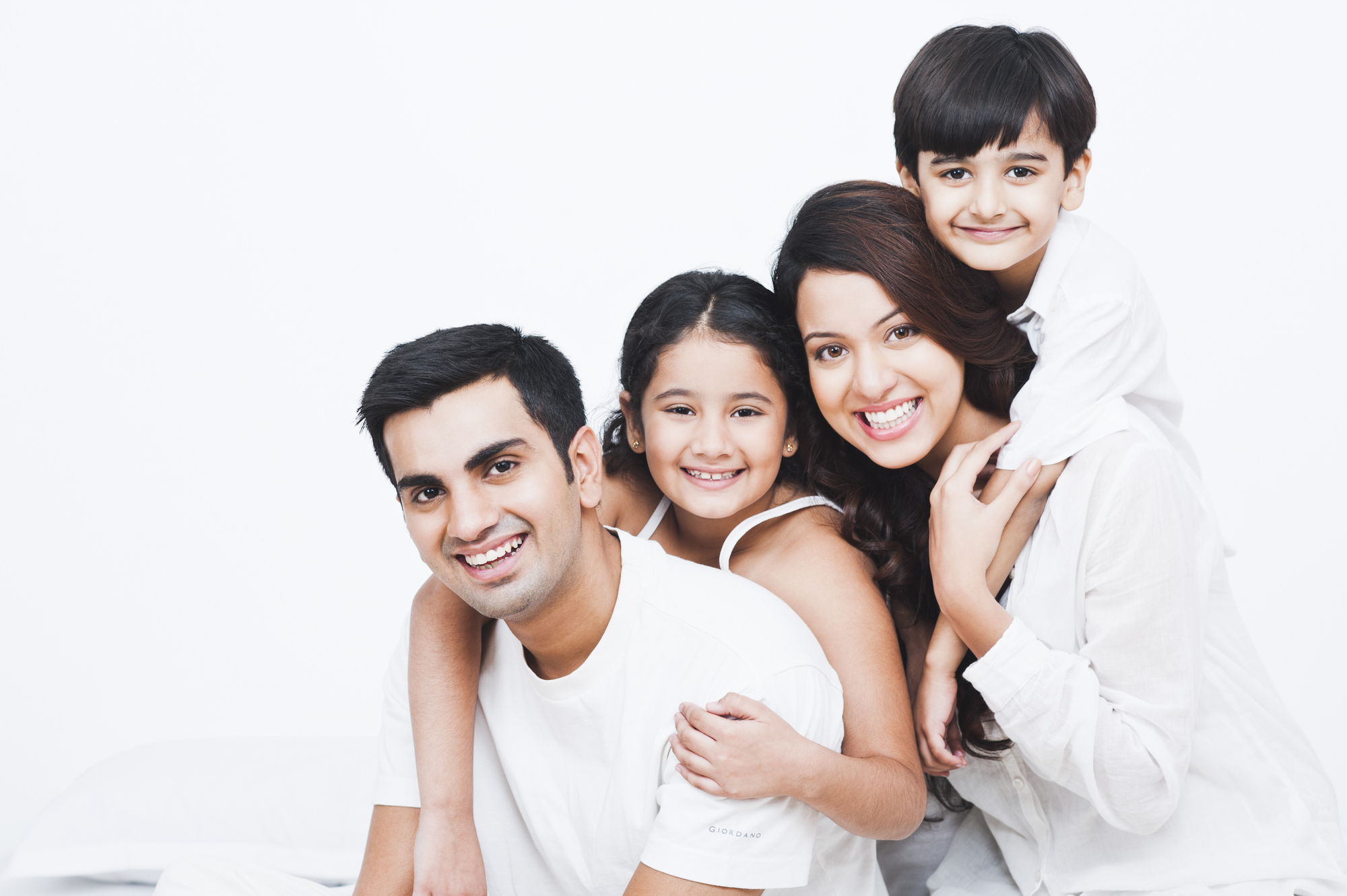 A happy family smiles together for a portrait