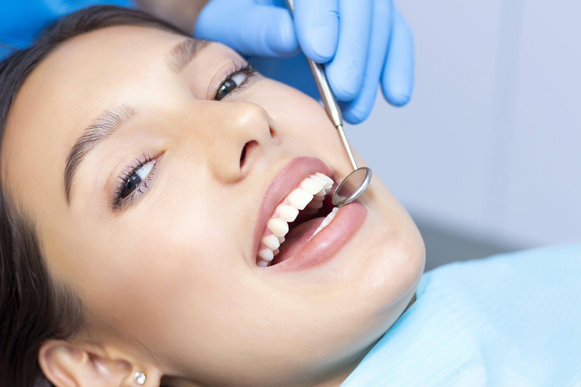 dentist in Las Vegas examines the patients teeth