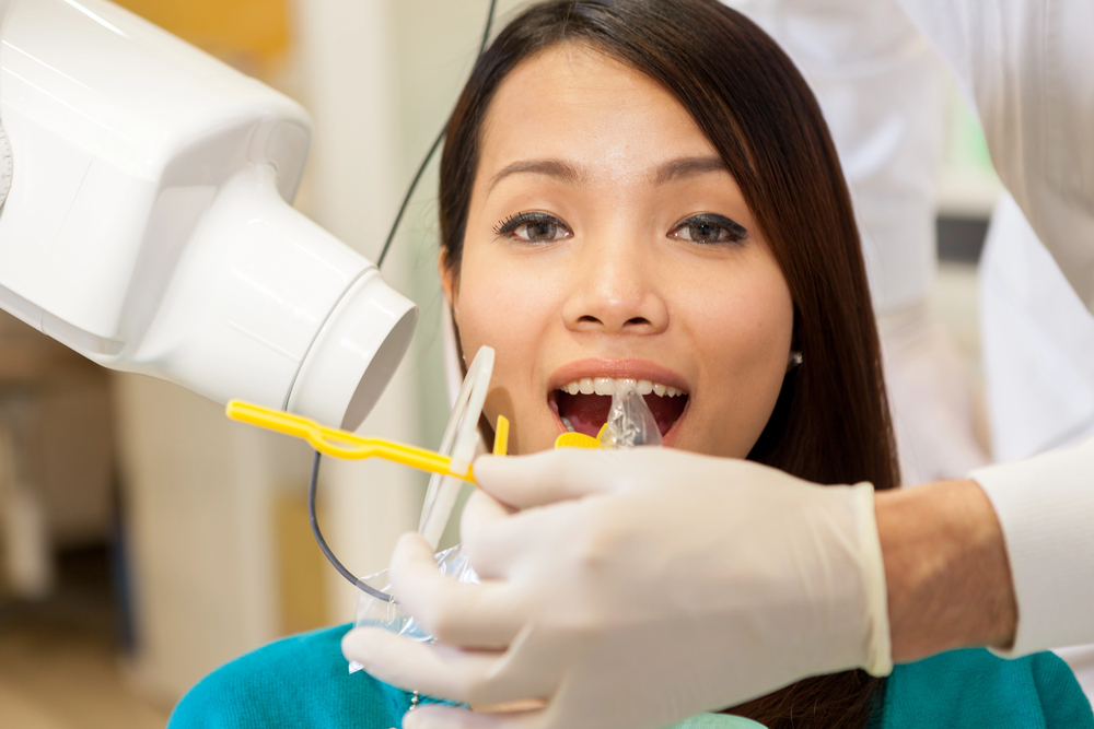 woman at the dentist using modern dental technology