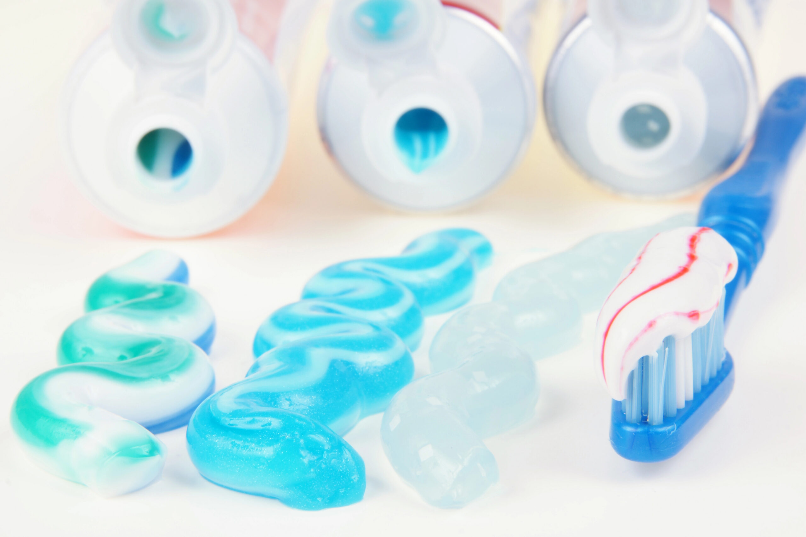 three different types of toothpaste and toothbrush